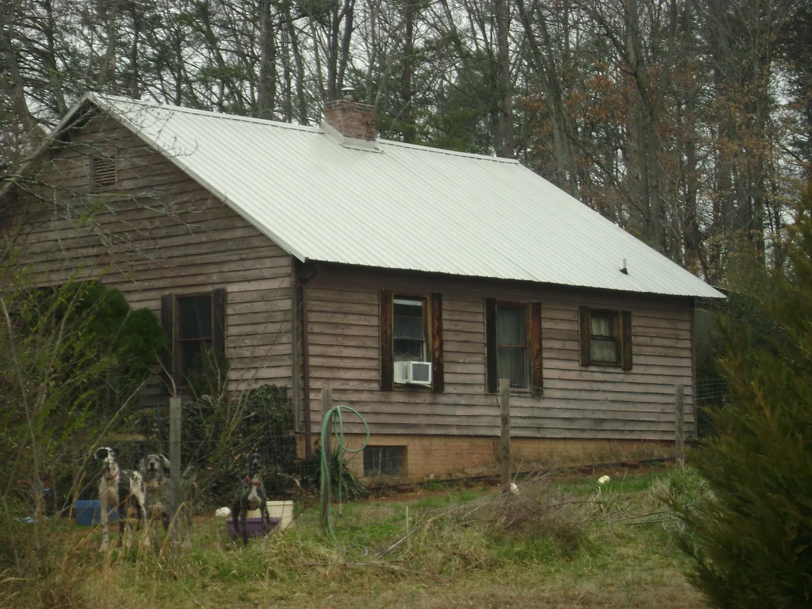 White metal roof on an old wood sided farmhouse, from a Metal Roof Installation job in Offutt Afb